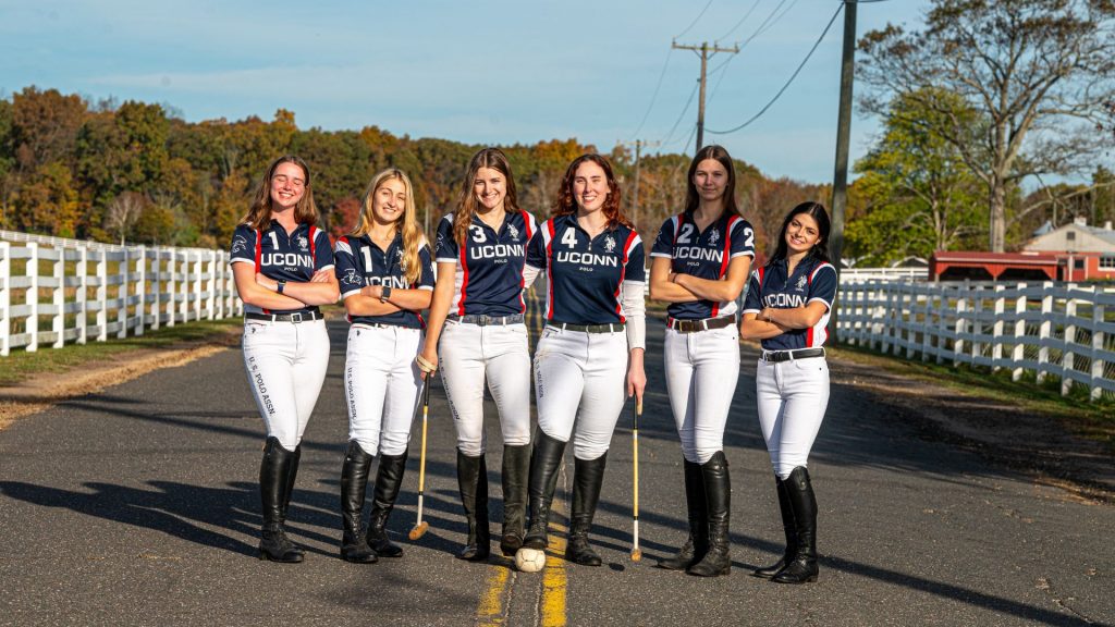The women's polo team poses together for a photo